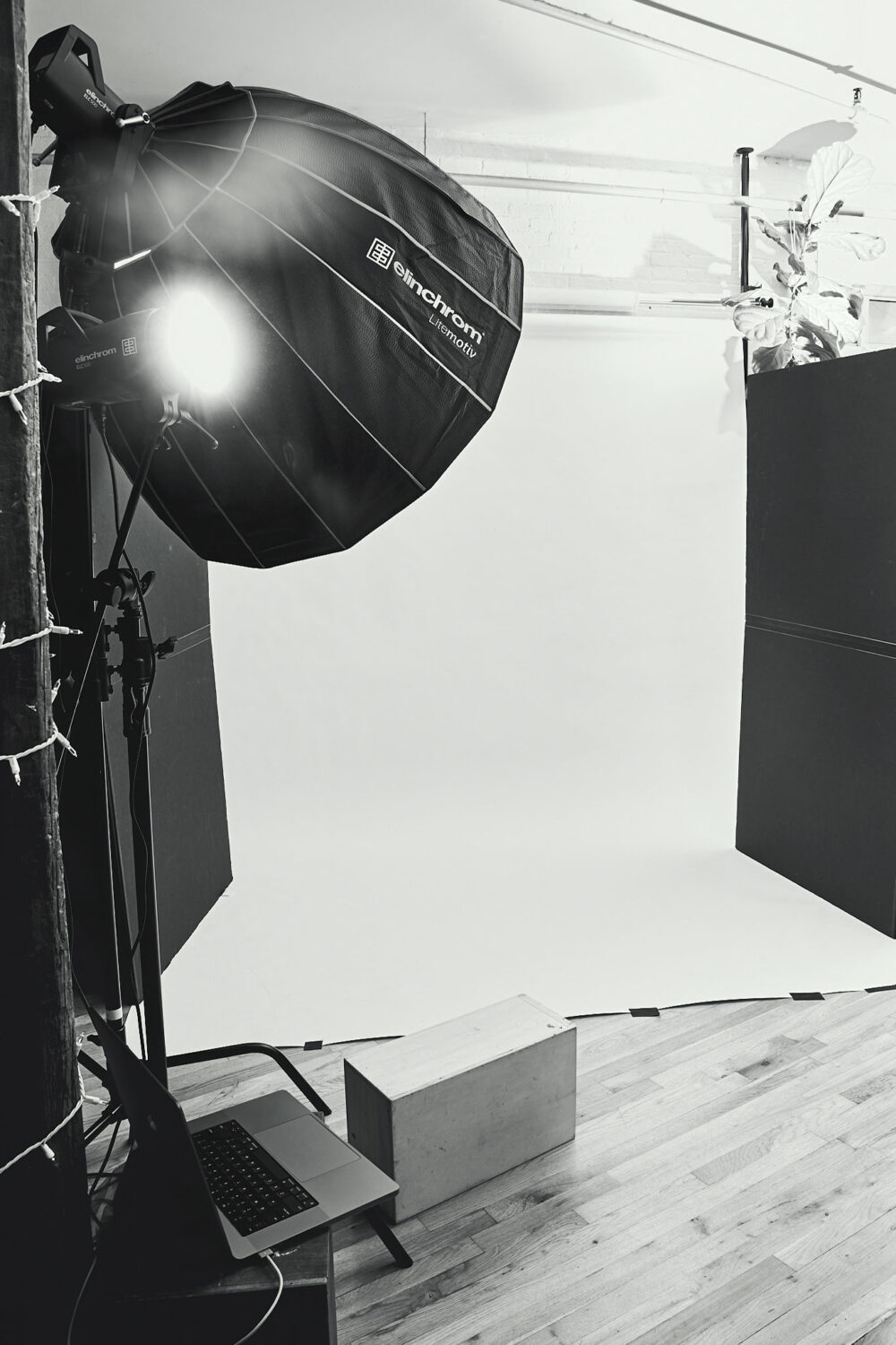 black and white picture of a photographic studio, behind the scenes of photographer Emily Teague's shooting